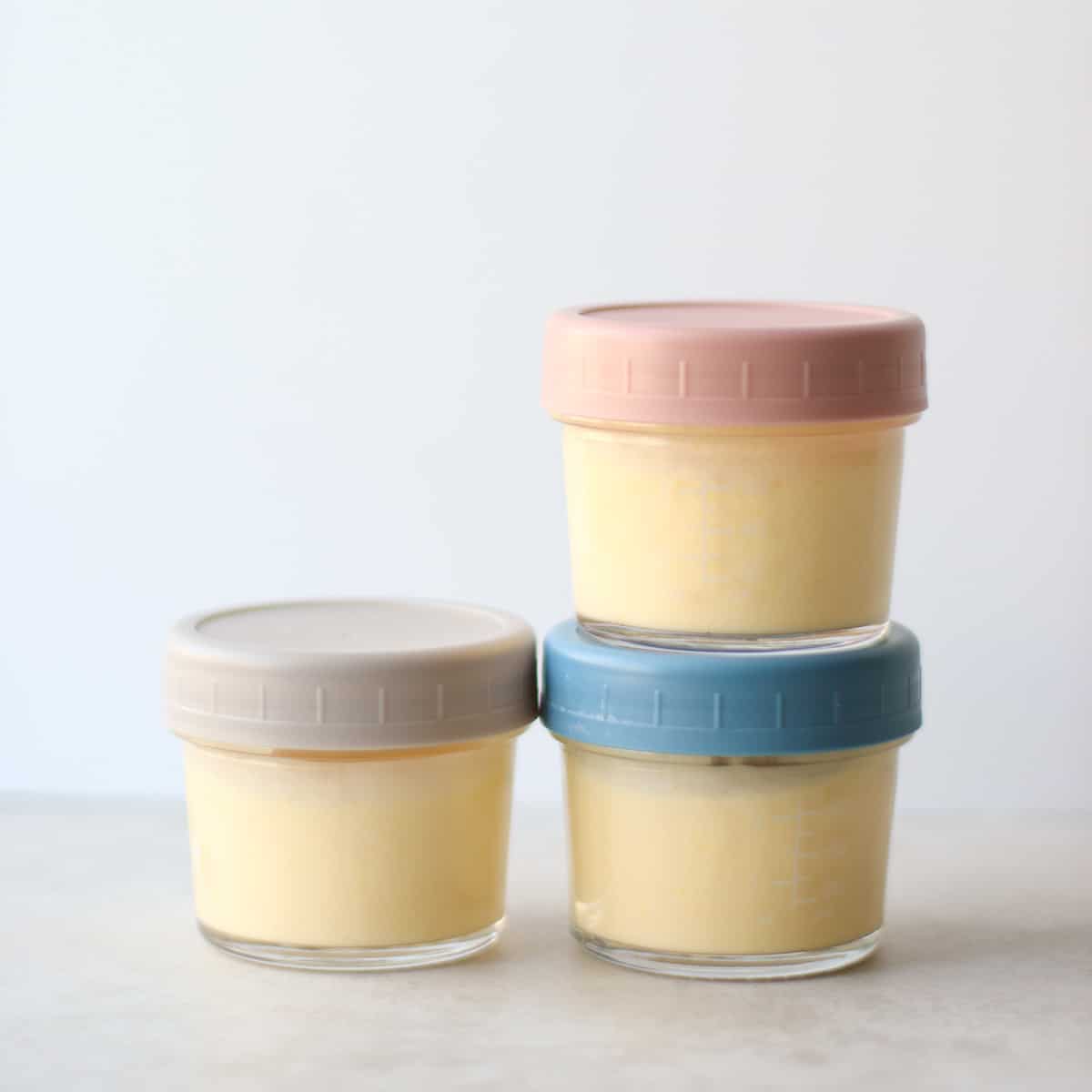 Three small glass containers with yogurt.