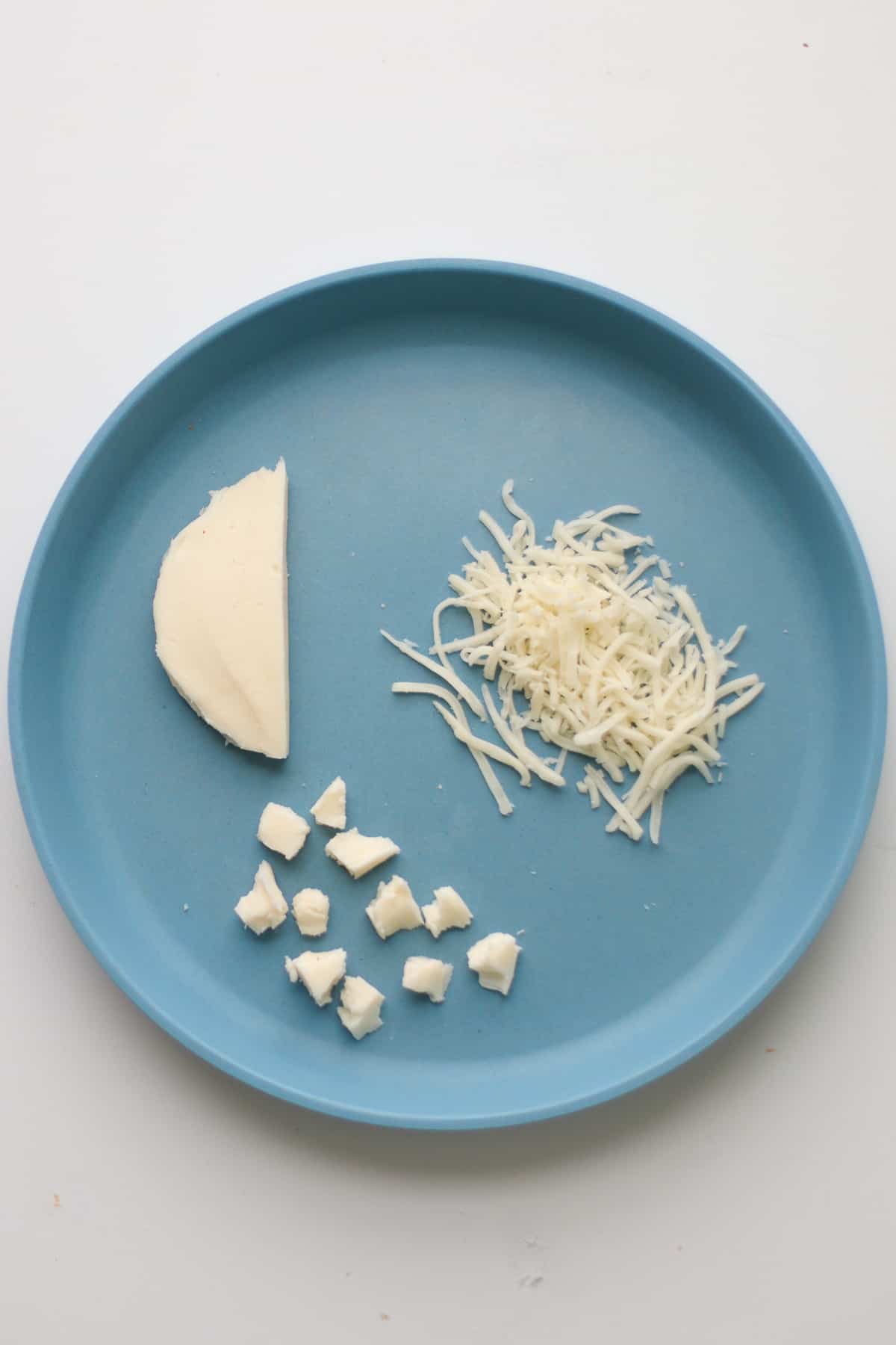Shredded, bite-sized, and big strip of mozzarella cheese.
