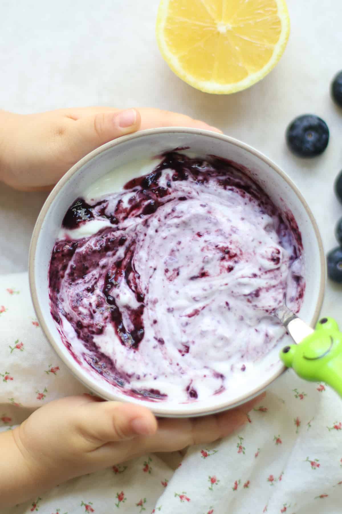An overhead shot of yogurt with blueberry puree.