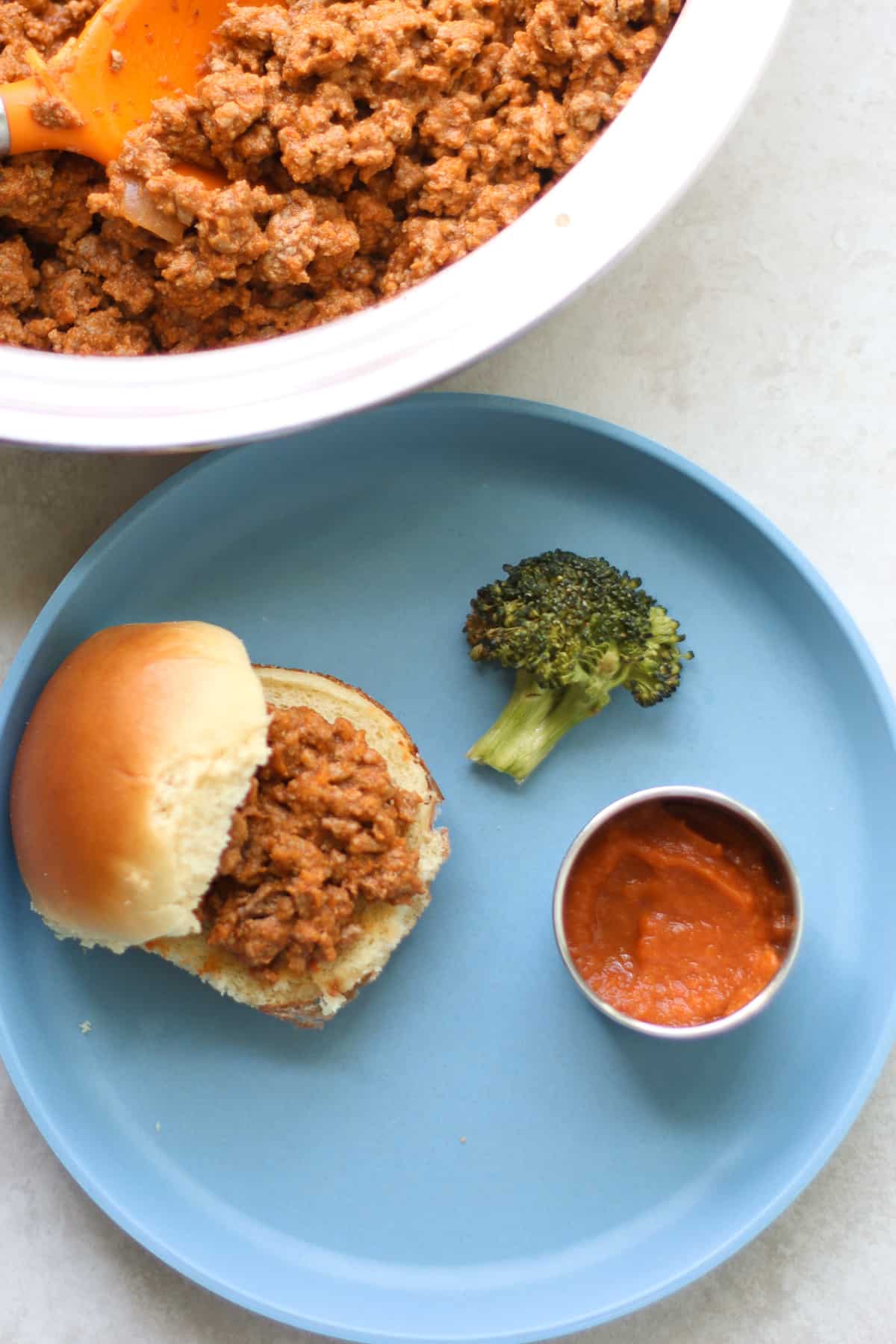 Mini sloppy joes with broccoli and a side of the sauce.