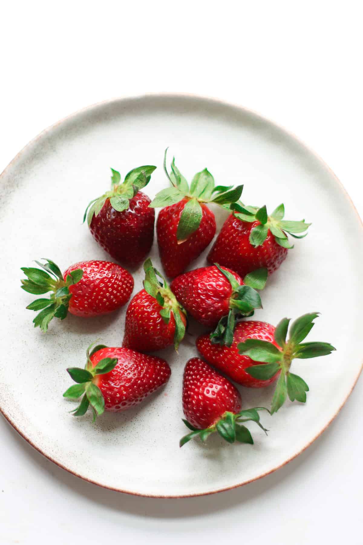 Fresh strawberries with stem on.