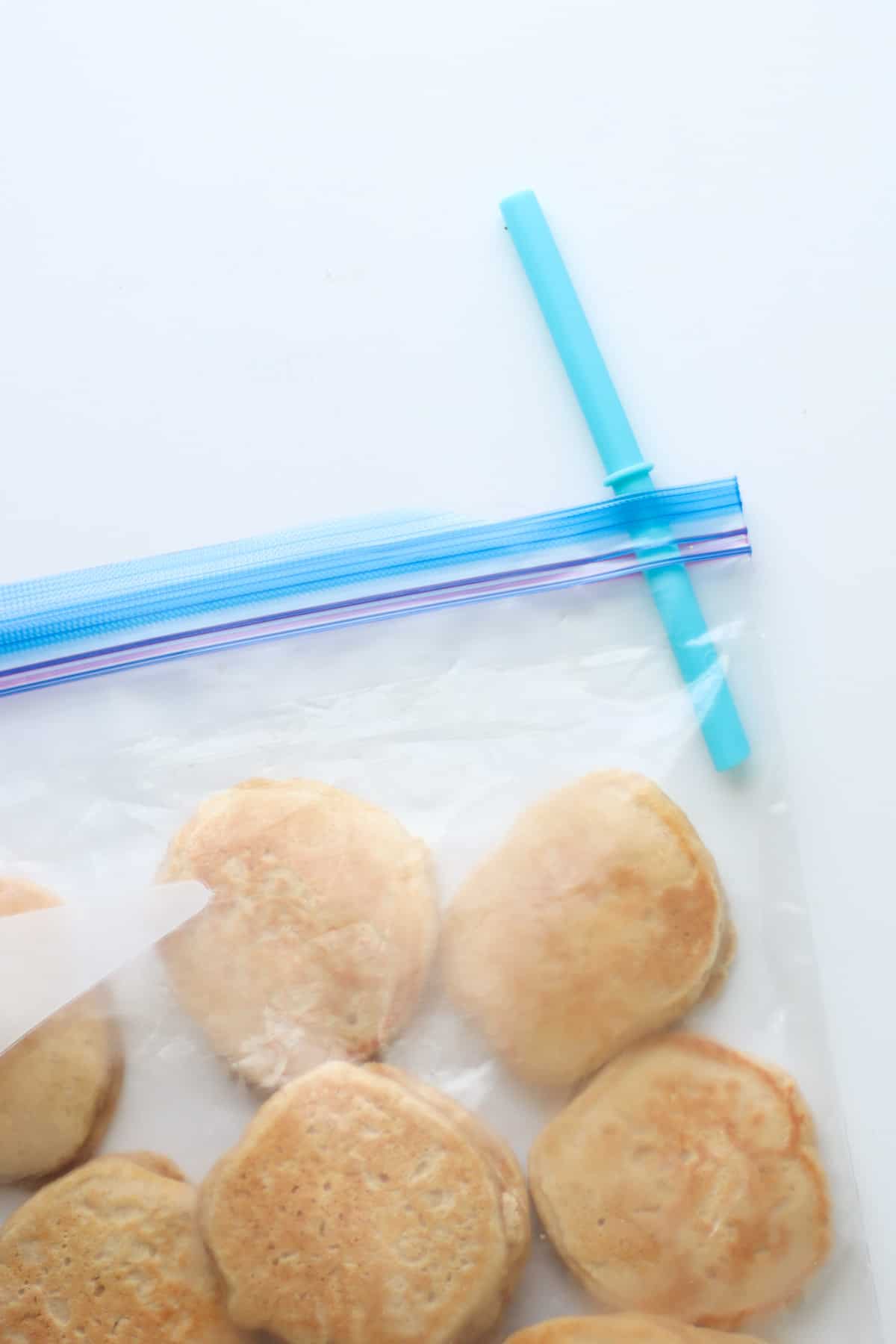 Pancakes in freezer bag with a large straw inserted in the corner.