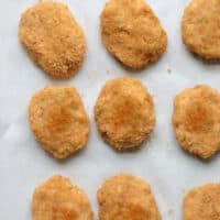 Baked golden nuggets on parchment paper.