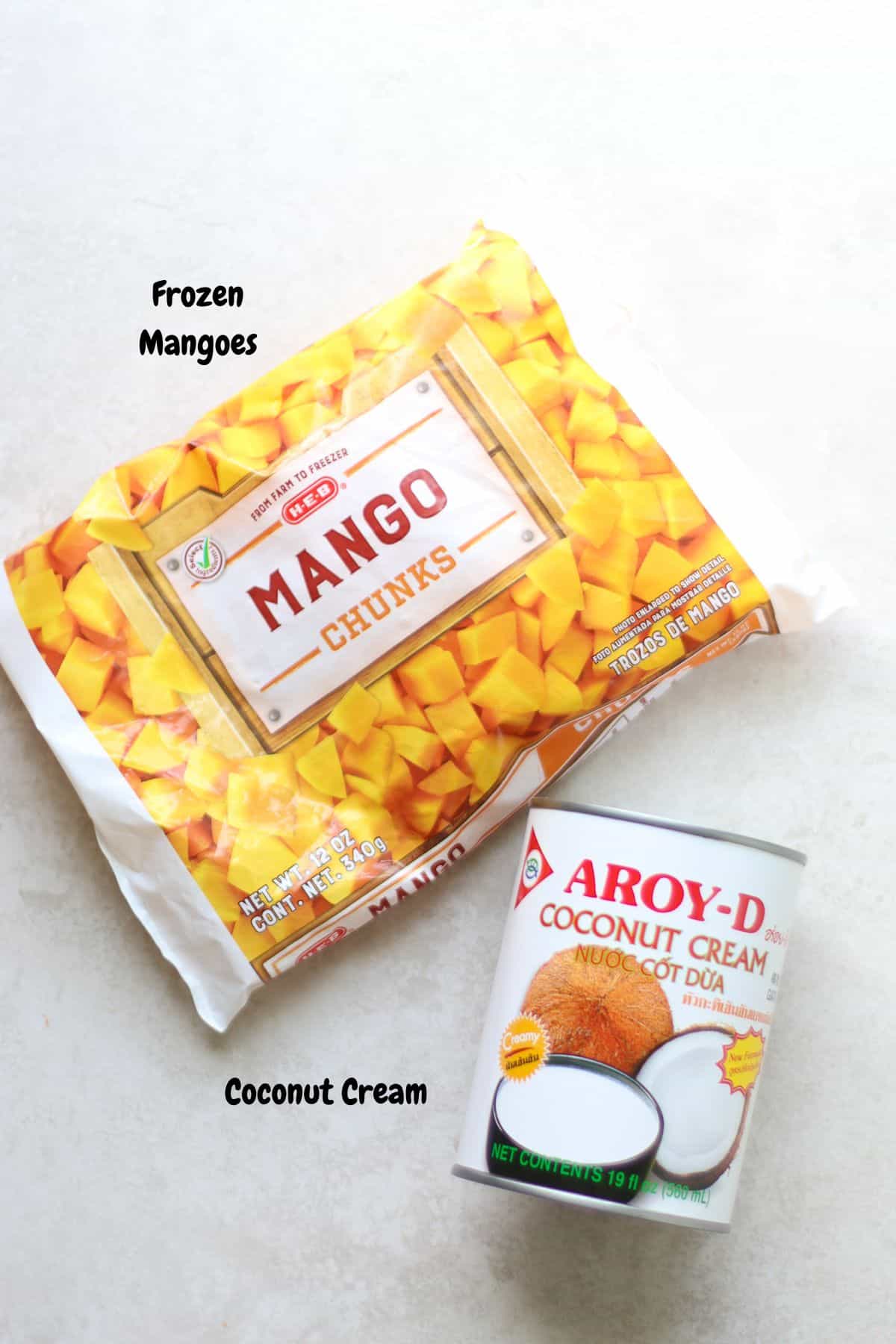 Frozen mangoes and coconut cream on a white background.