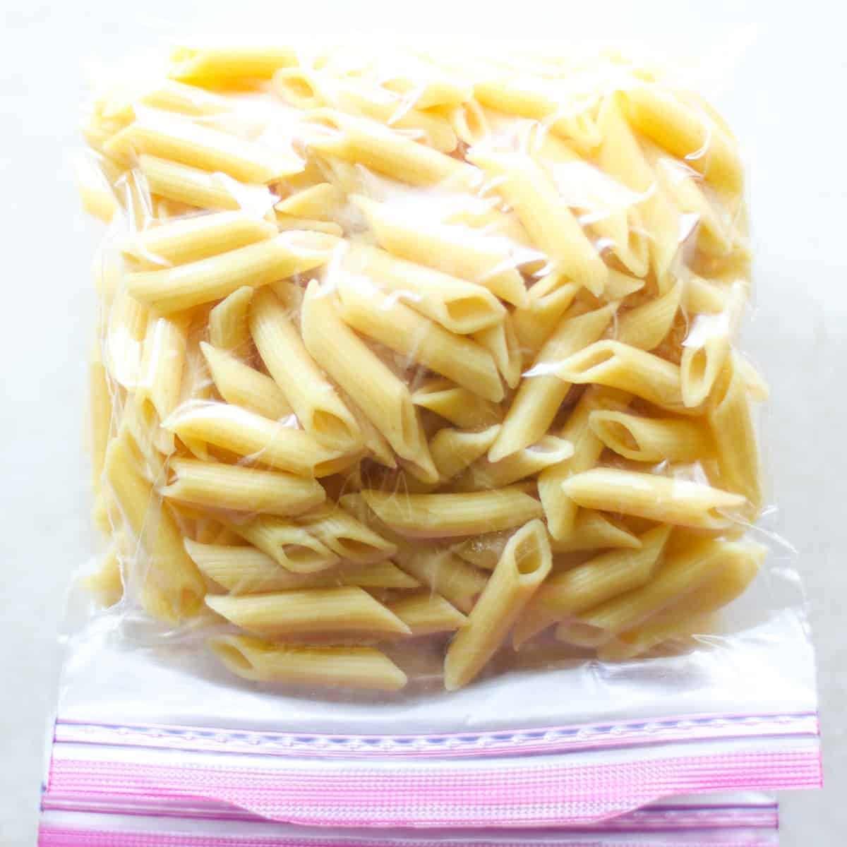 Single-serving pasta in freezer safe bag and laid flat.