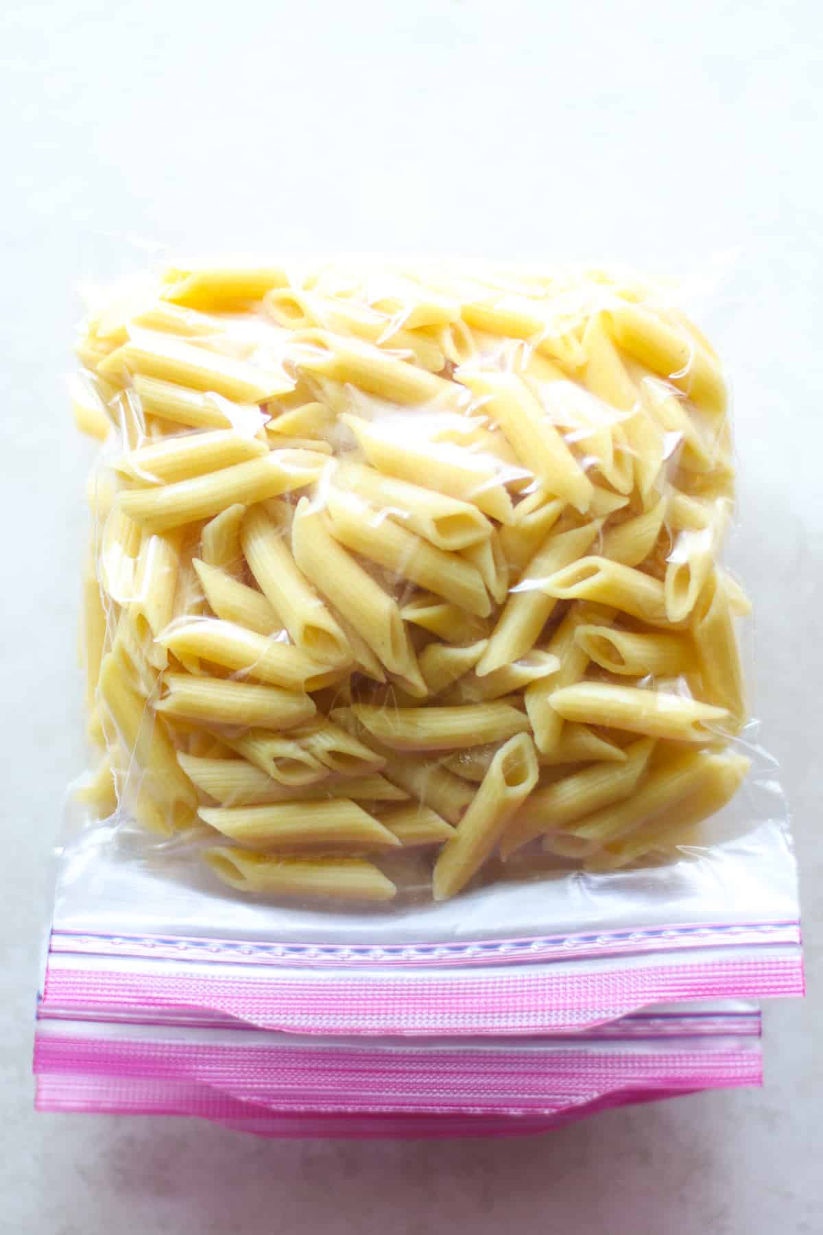 Single-serving pasta in freezer safe bag and laid flat.