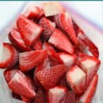 A close up shot of frozen strawberries in freezer-safe bag.