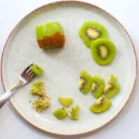 Kiwi sliced in appropriate ways for babies 6+ months and 9+ months.