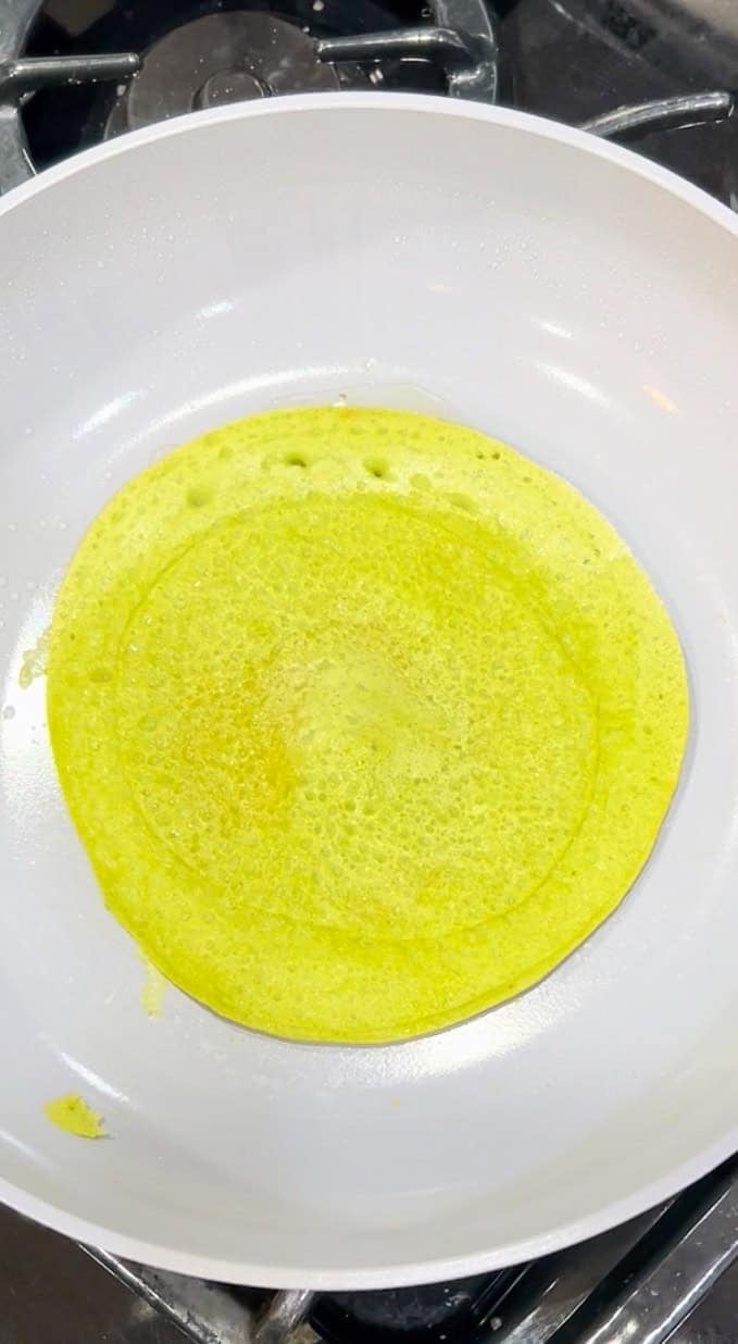 A cooked lentil wrap on a nonstick skillet.