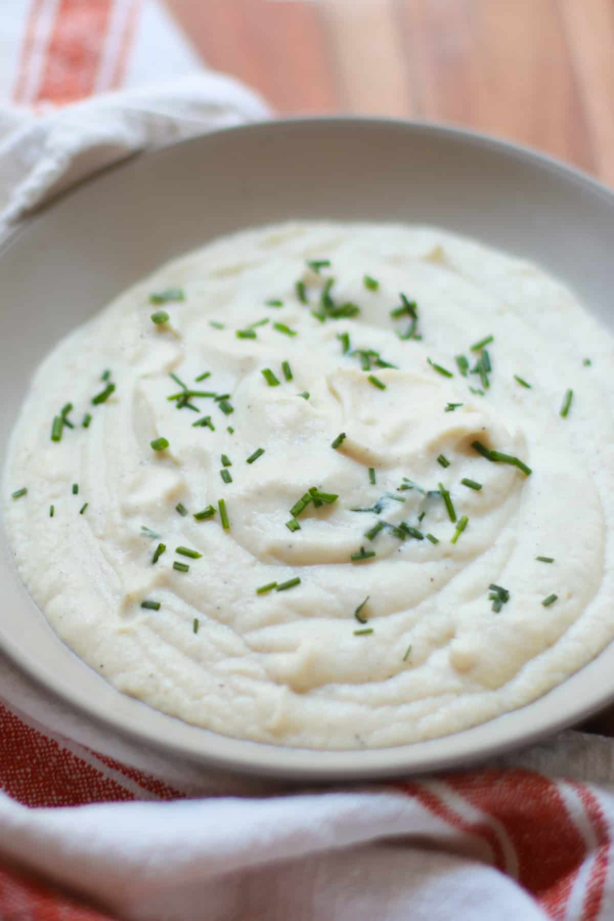 A close shot of mashed cauliflower with chives.