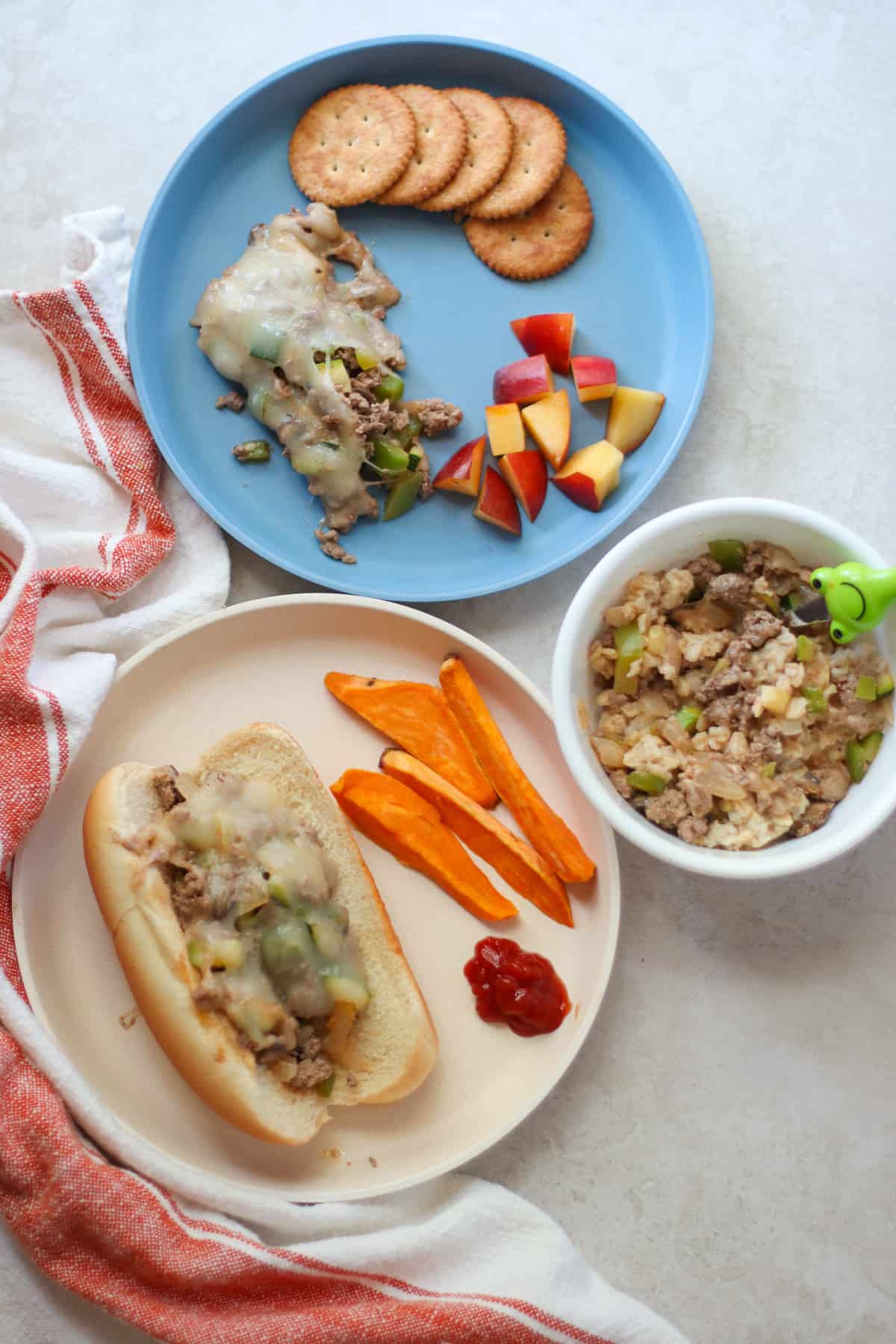 Cheese steak casserole served three ways as a sandwich, deconstructed with crackers, and mixed with oatmeal.