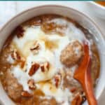 Pumpkin chia pudding with yogurt and chopped pecans in a large bowl.