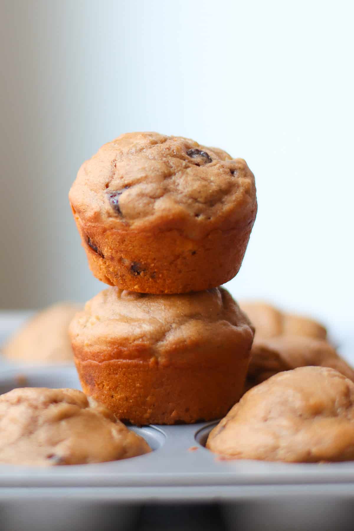 Two muffins stacked on muffin pan.