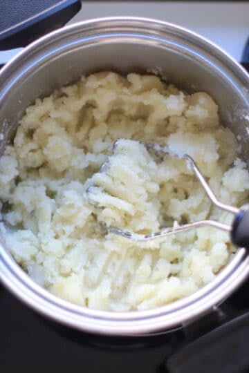 Mashing using a potato masher.