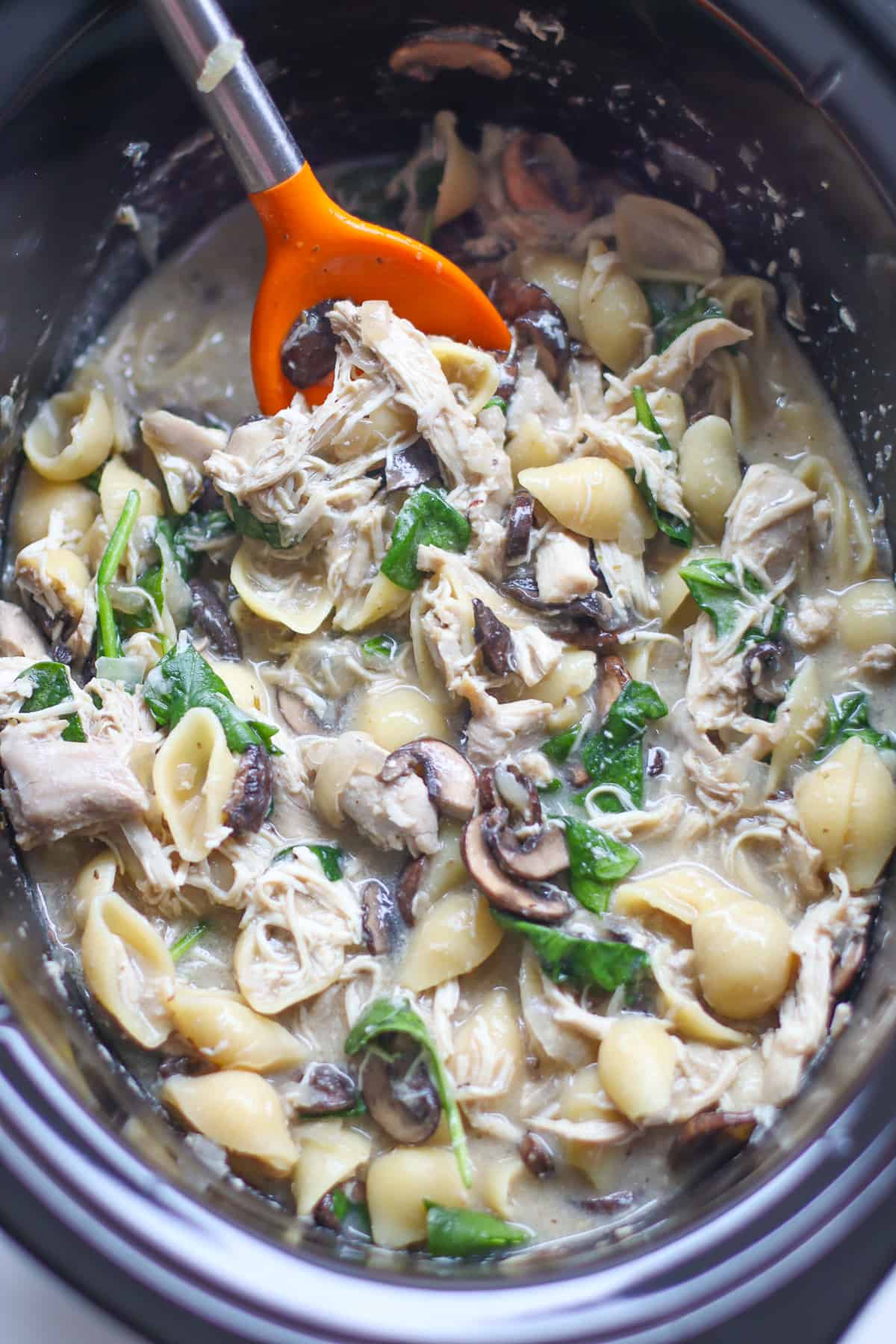 Cooked chicken and mushrooms in slow cooker.
