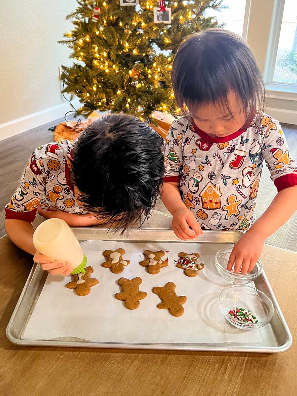 Two children decorating the cookies.