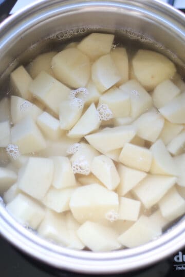 Potatoes in a pot of cold water.