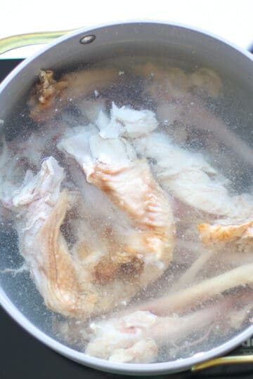 Turkey carcass in a pot with cold water.