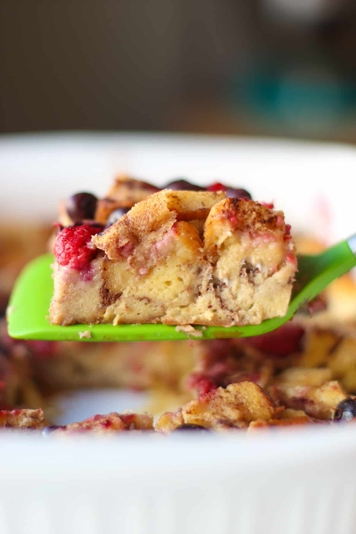 A straight shot showing the inside of baked French toast casserole on a spatula.