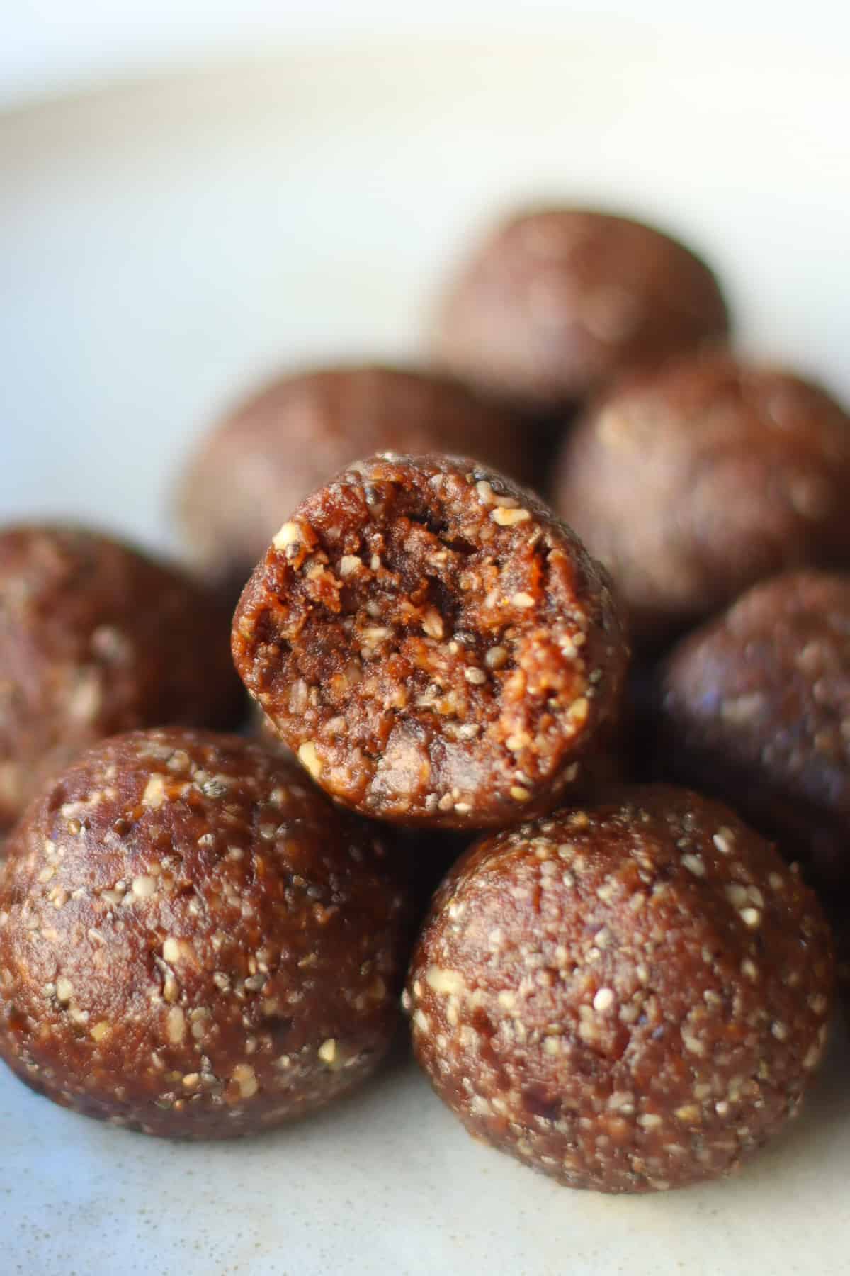 Close-up of stacked chocolate balls with a bite taken out.