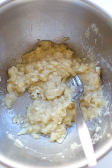 Mashed bananas in a mixing bowl.