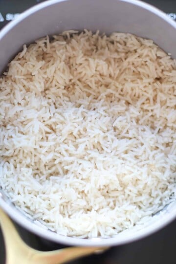 Cooked white rice in a white dish.