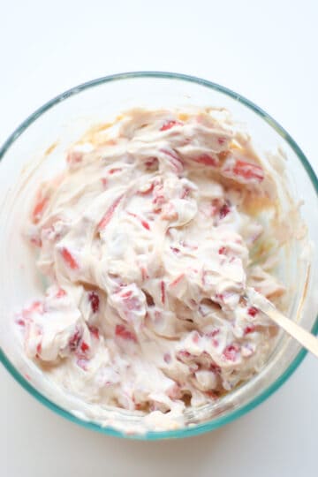 Yogurt, strawberries, peanut butter combined in a large glass bowl.