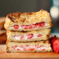 Close up of a stack of stuffed french toast with a strawberry cream cheese filling.