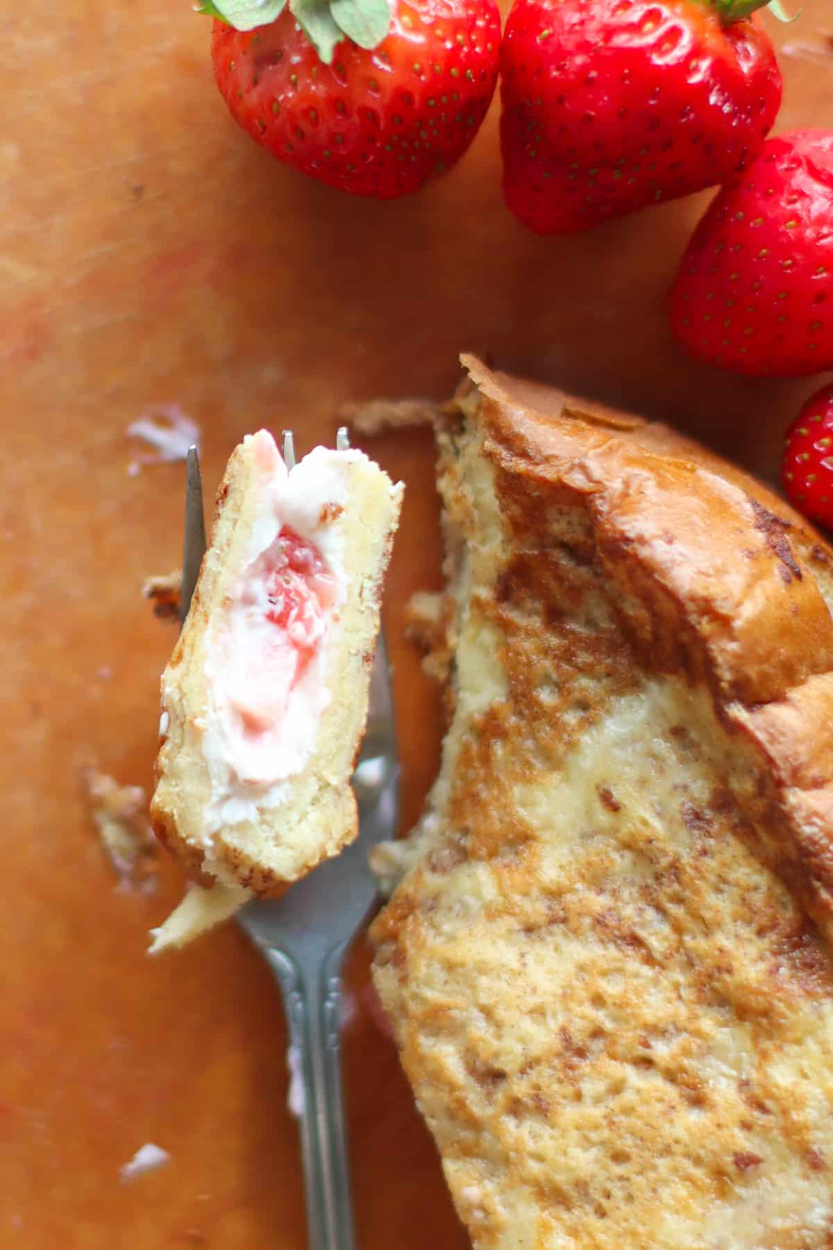 A fork with a bite of stuffed french toast.