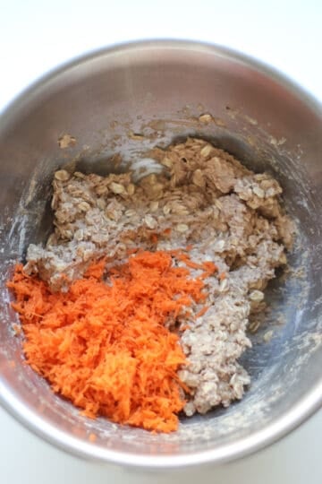 Carrots added to all ingredients in a bowl.