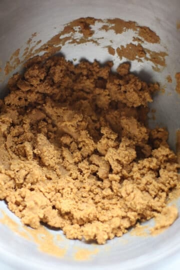 Uncooked graham cracker dough in a bowl.
