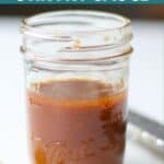 Sauce in a clear mason jar sitting on a white countertop.