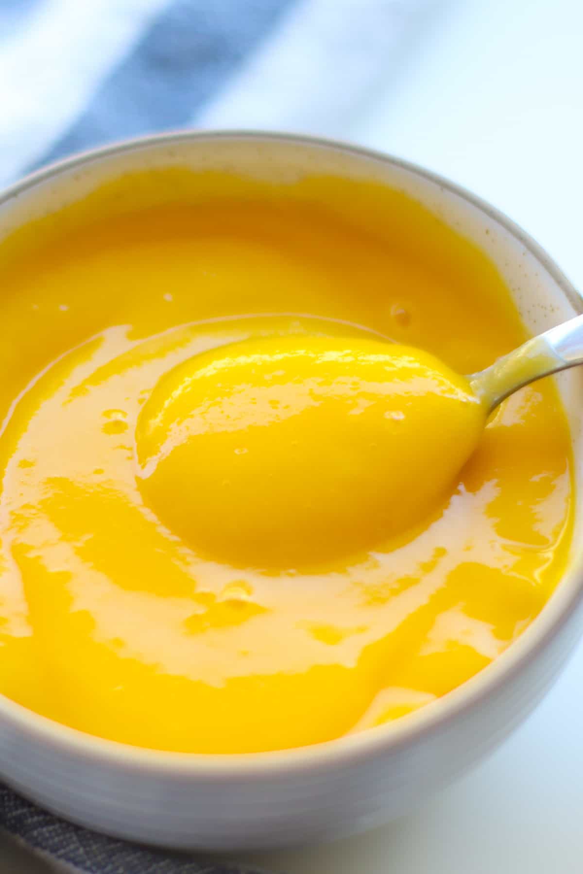 Scooped mango puree in a bowl.