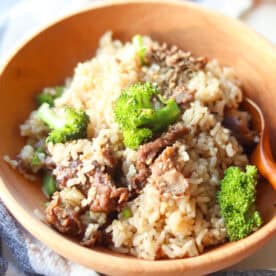 Cooked rice cooker beef and broccoli in a wooden bowl.