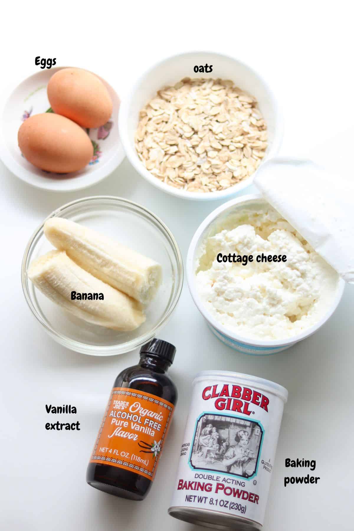 All ingredients for cottage cheese pancakes portioned out on a white countertop.