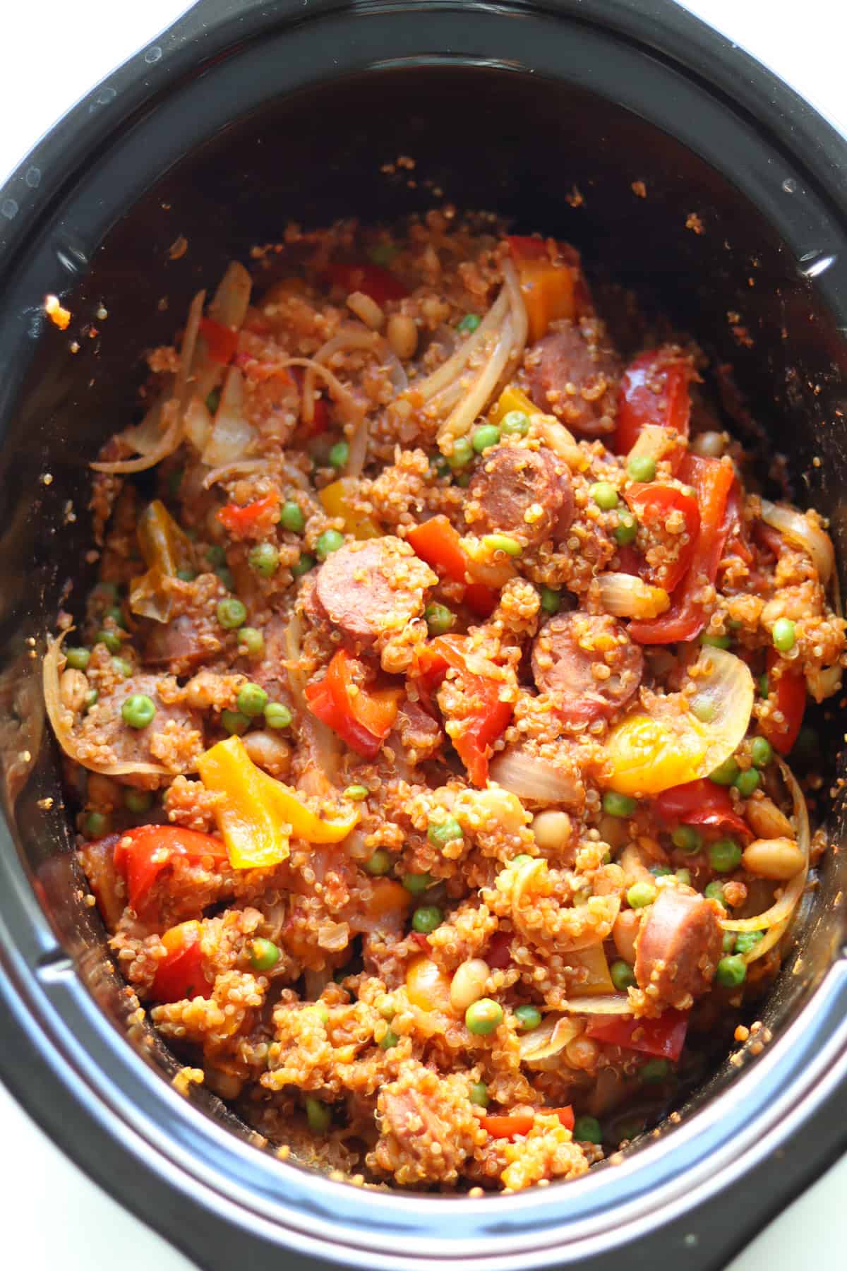 Finished slow cooker sausage casserole in a black crockpot. 
