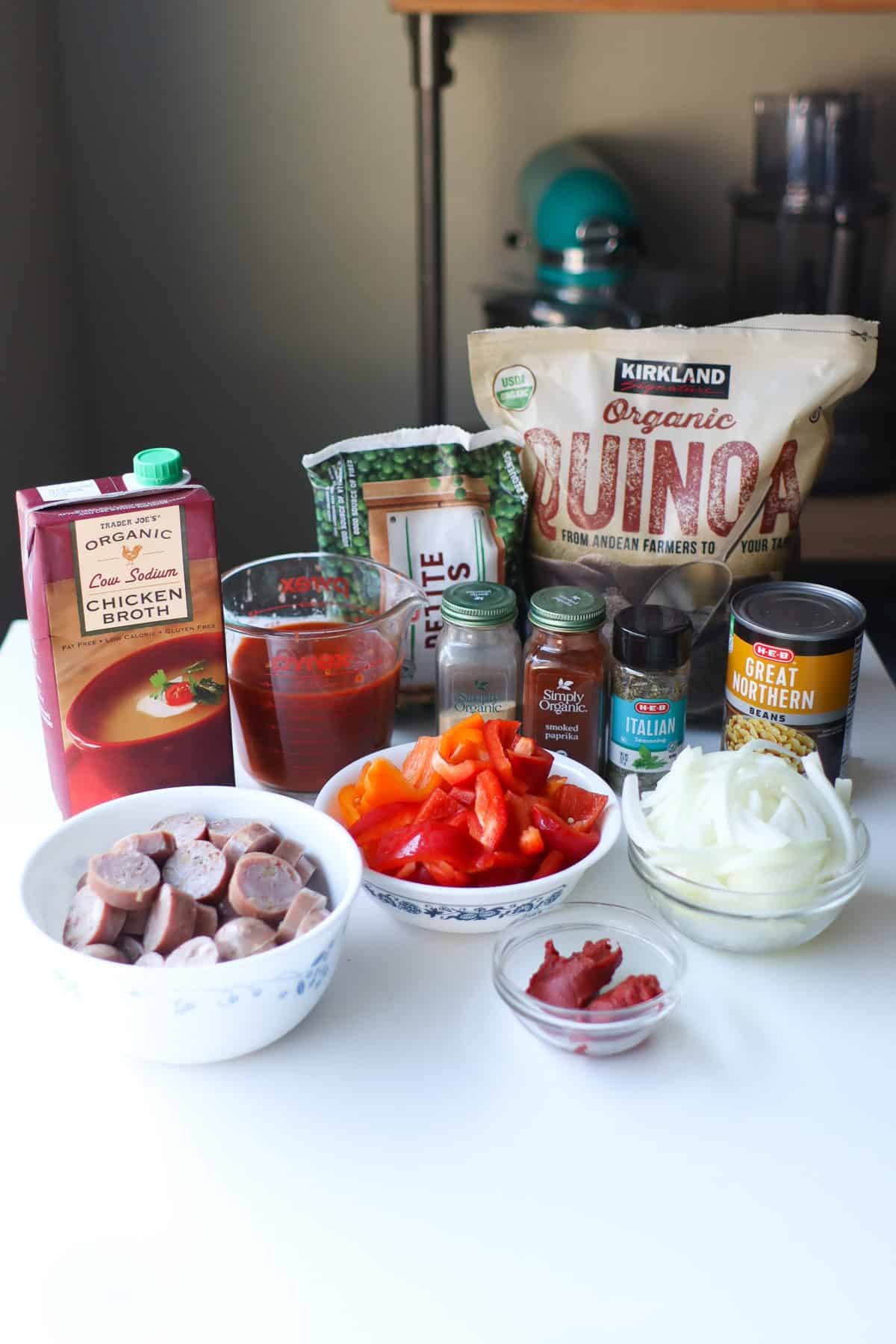 All of the ingredients for the sausage casserole sitting on a white countertop.