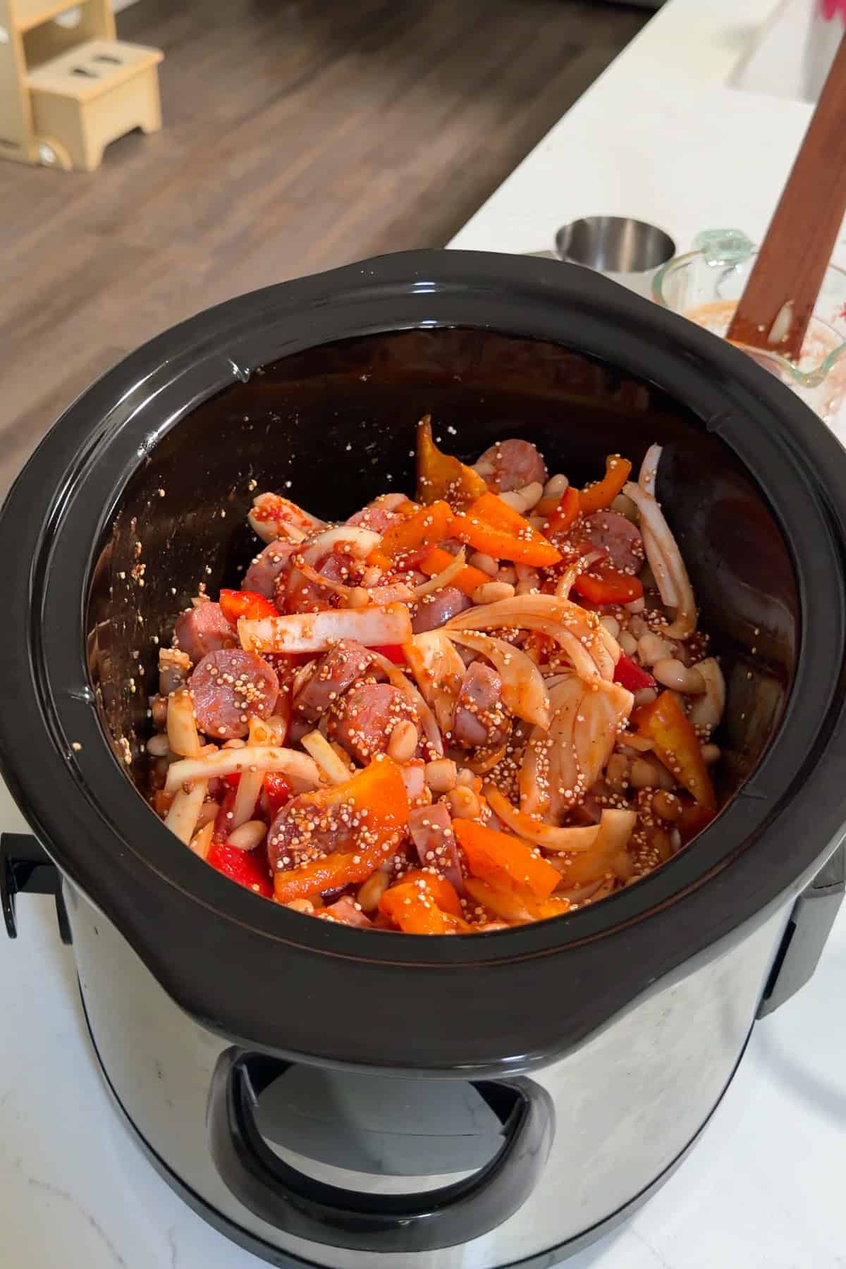 All ingredients for the sausage casserole added to the crockpot, except for the peas. 