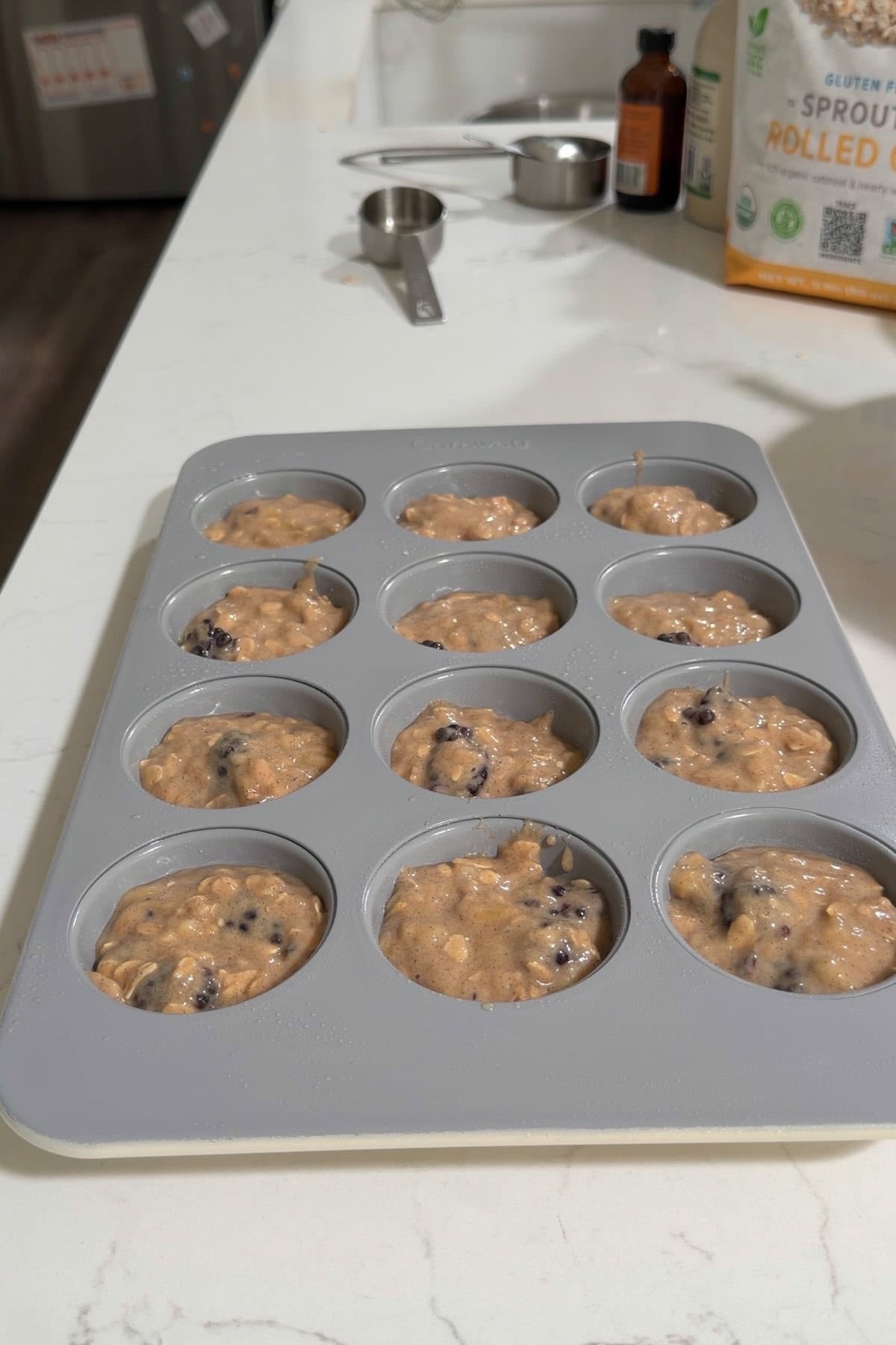 Batter transferred to a muffin pan.