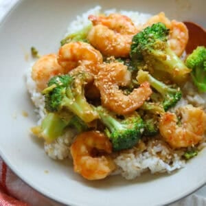 Shrimp broccoli stir fry over rice in a bowl.