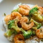 Shrimp broccoli stir fry over rice in a bowl.
