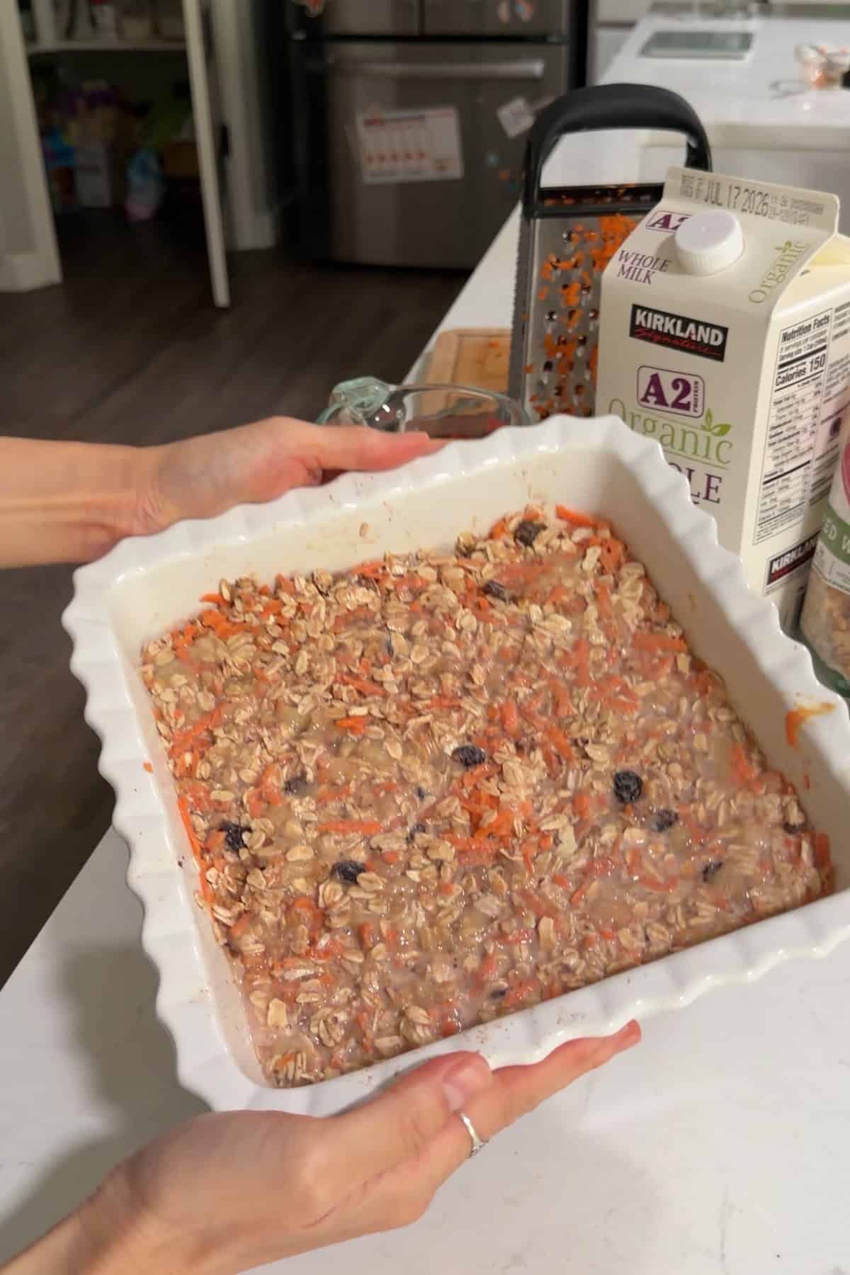 All the ingredients combined and soaked in milk in a white square baking dish.