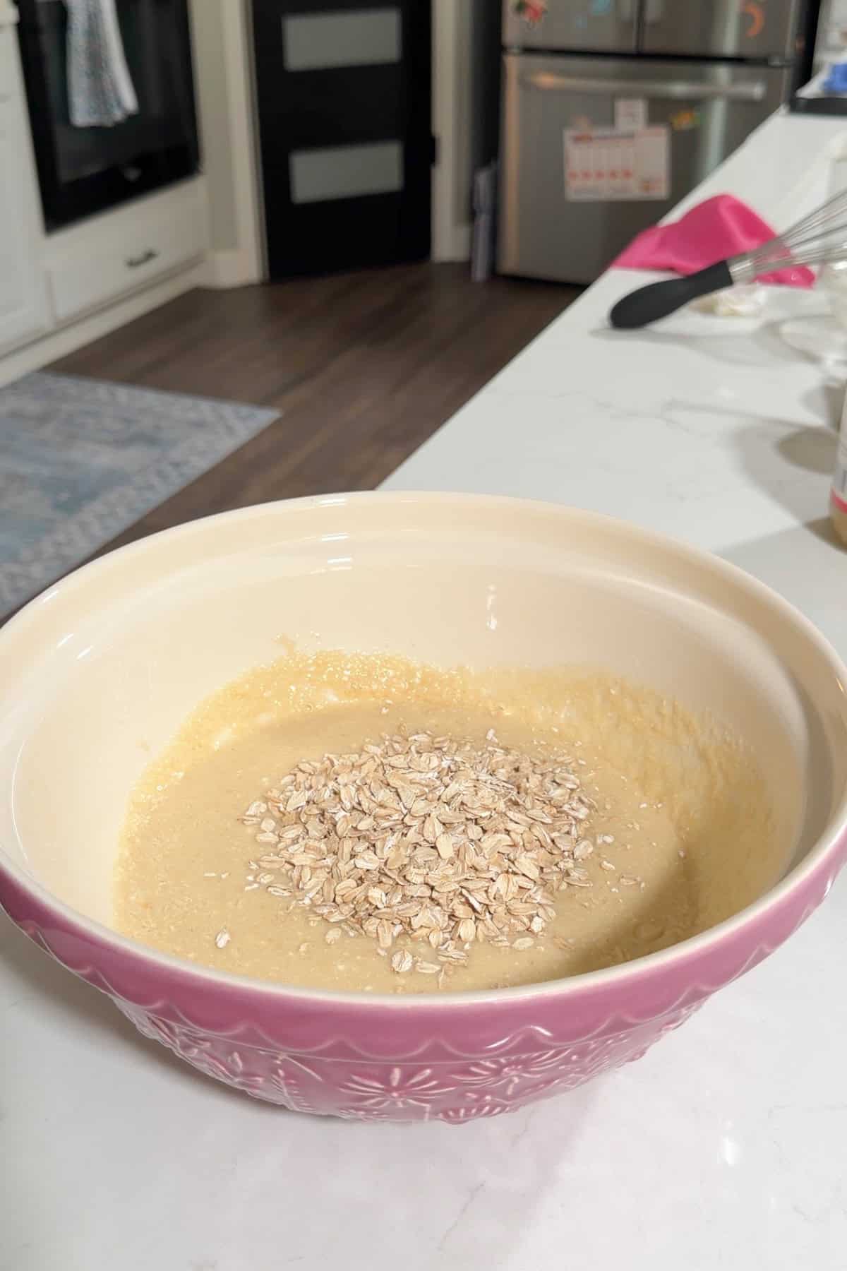 Rolled oats mixed into the batter and left to soak in a large bowl.