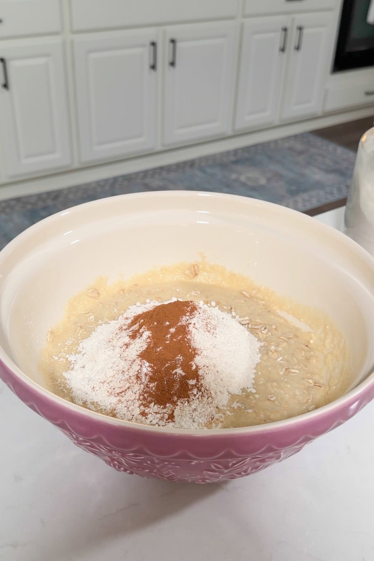 Flour and spices added to the batter in a large mixing bowl.