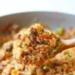 Korean beef and rice scooped on a large wooden spoon.