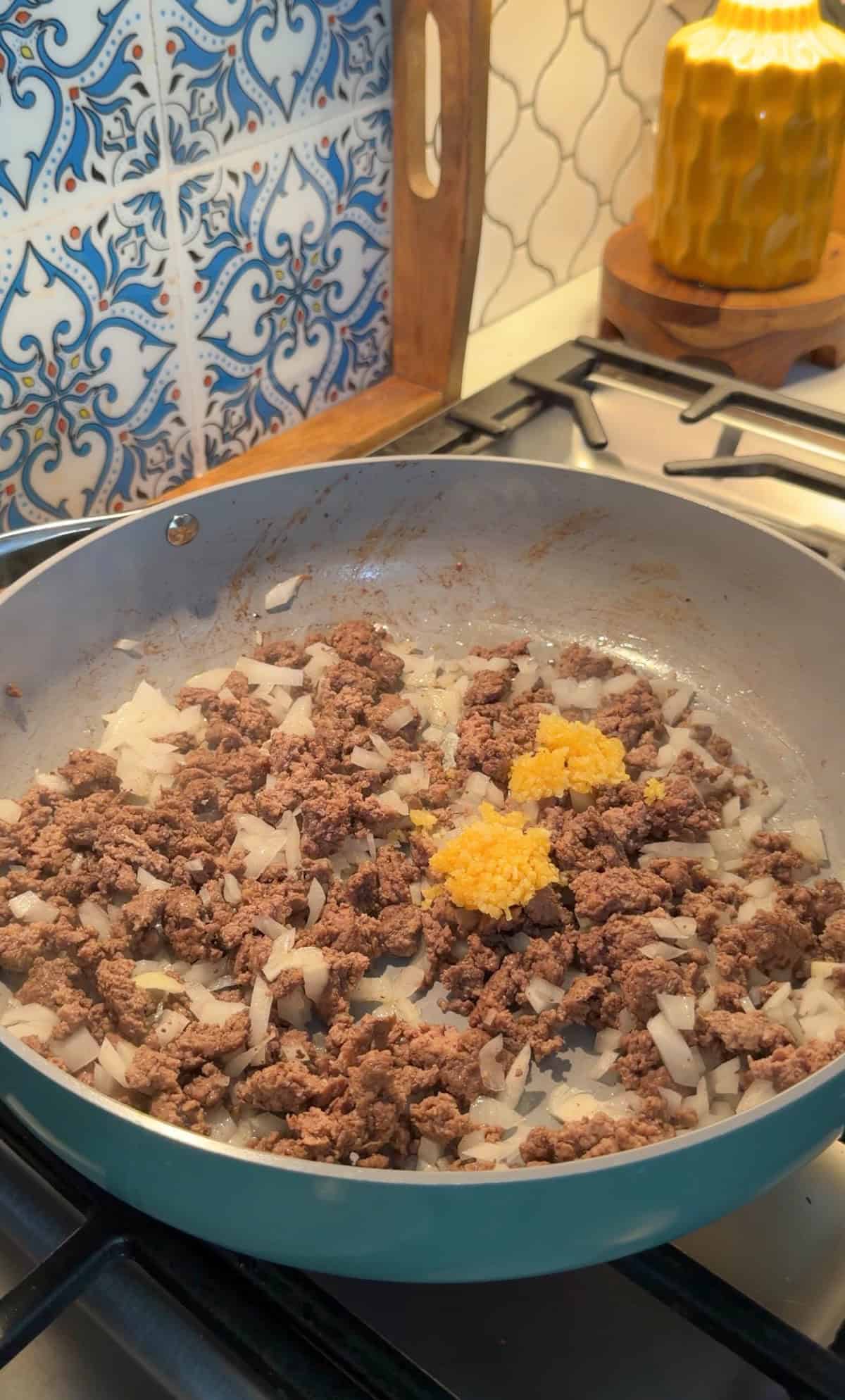 ground beef cooked in a skillet.