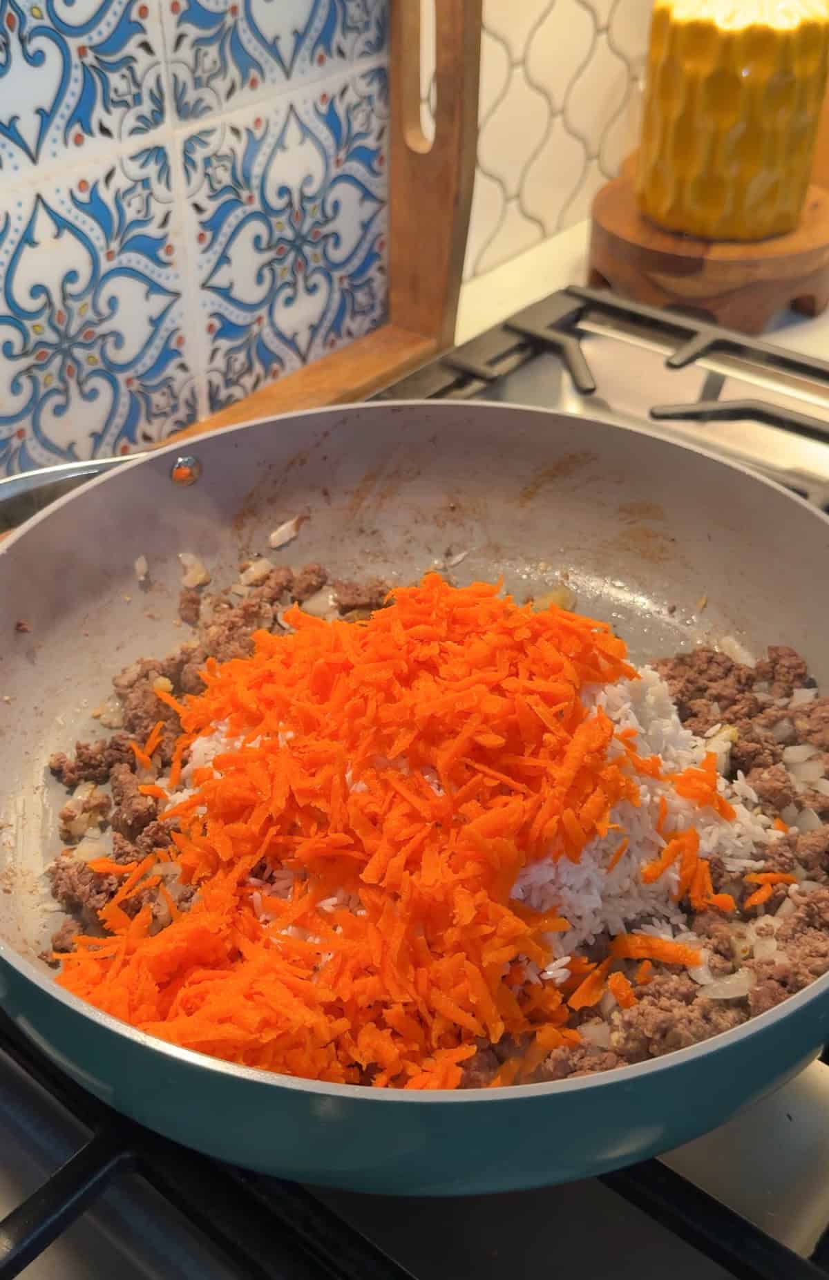 Carrots added to the skillet.