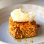 A slice of pumpkin baked oatmeal topped with mascarpone and maple syrup.