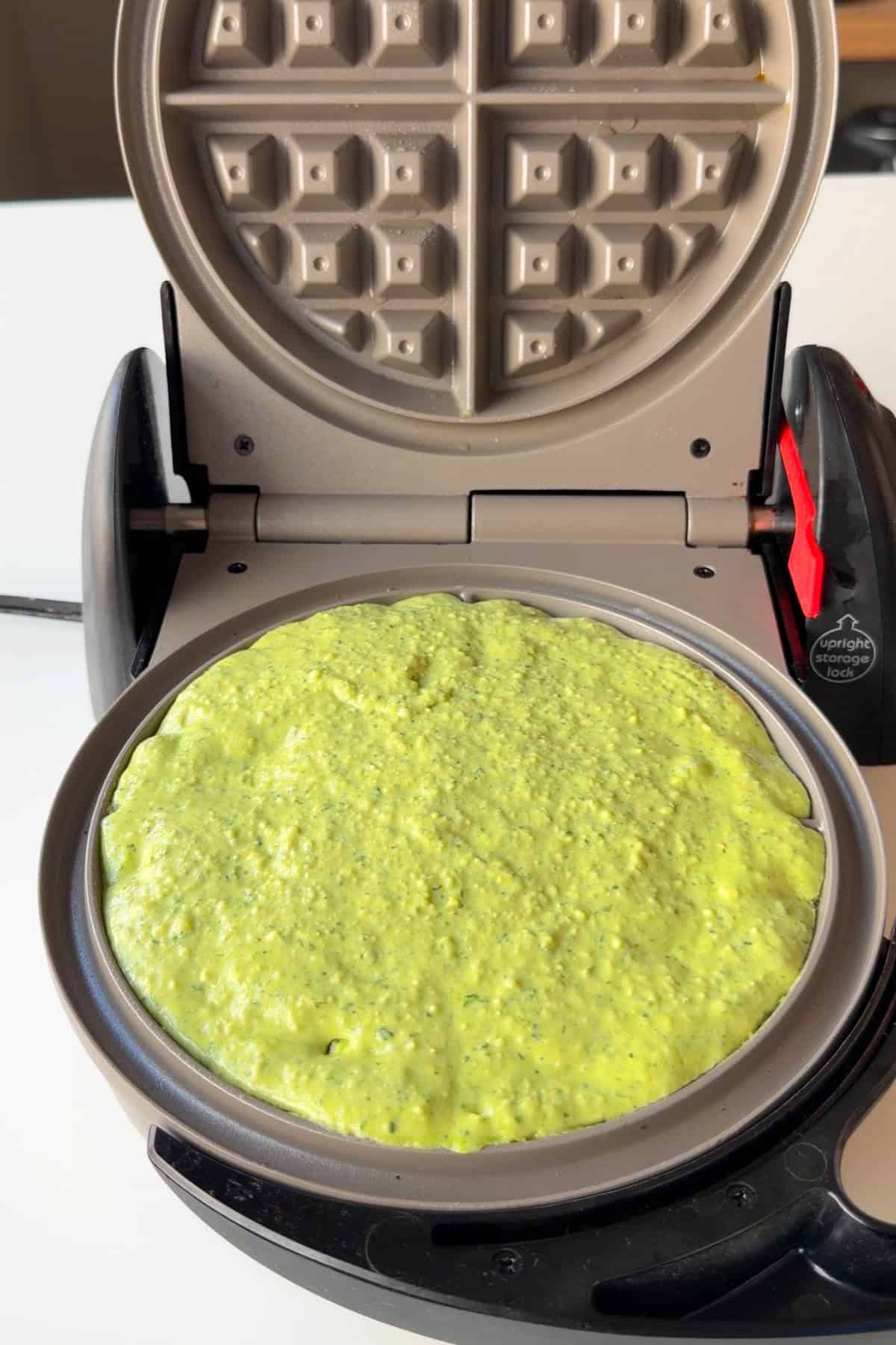 Savory waffle batter added to a waffle maker.
