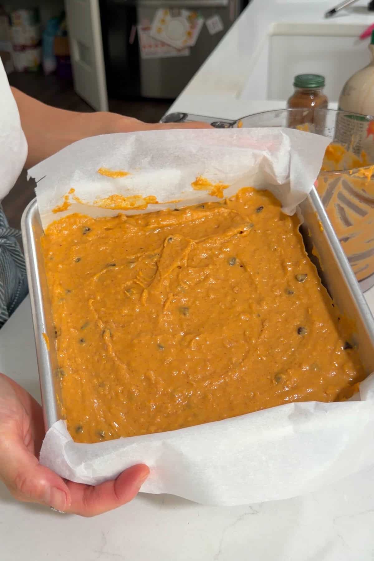 Batter poured into a lined square baking pan.